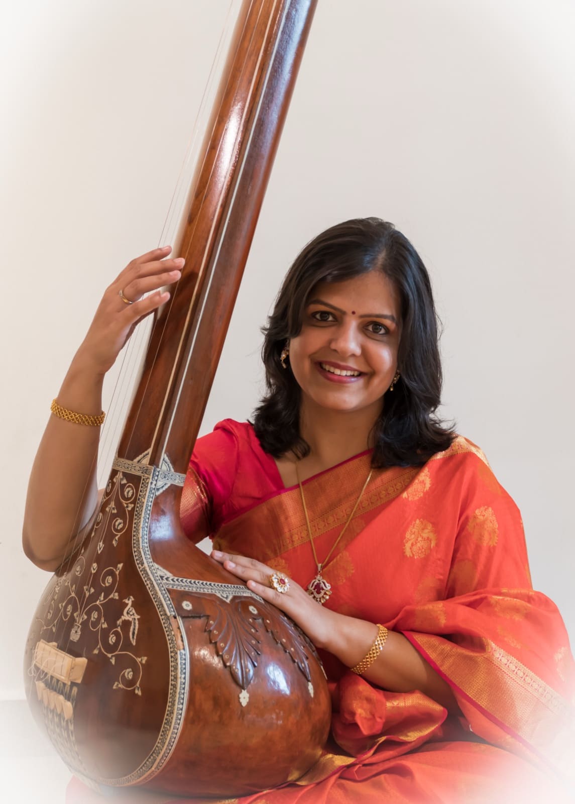 Dr. Ankita Deole Damle seated with a tanpura
